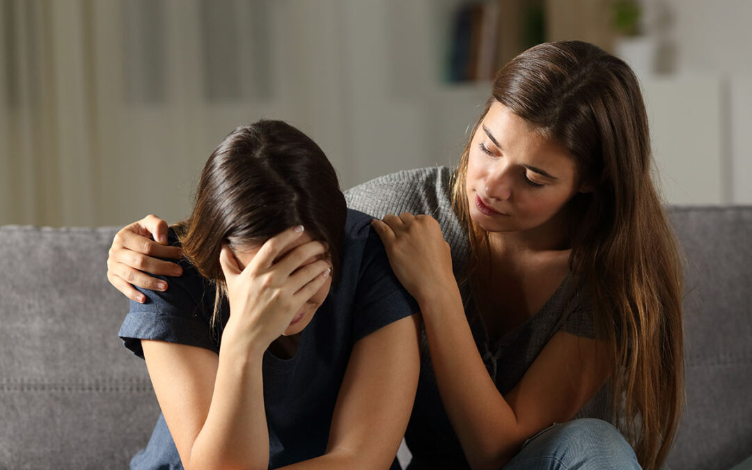 Teen comforting her sad friend in the night