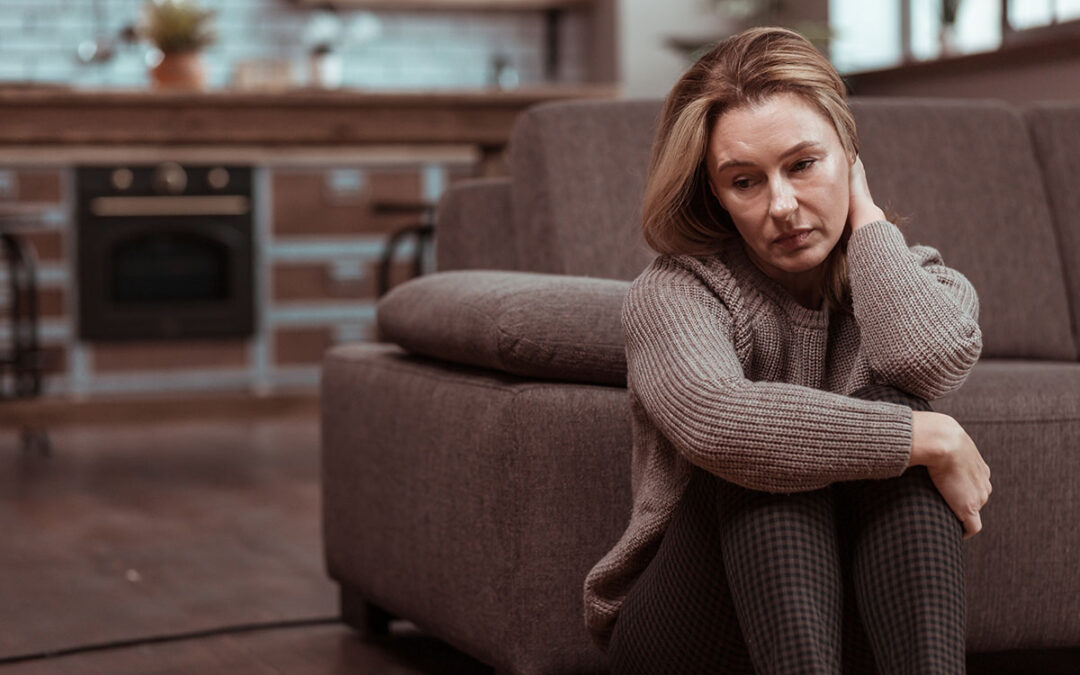 Woman wearing brown squared trousers feeling depressed